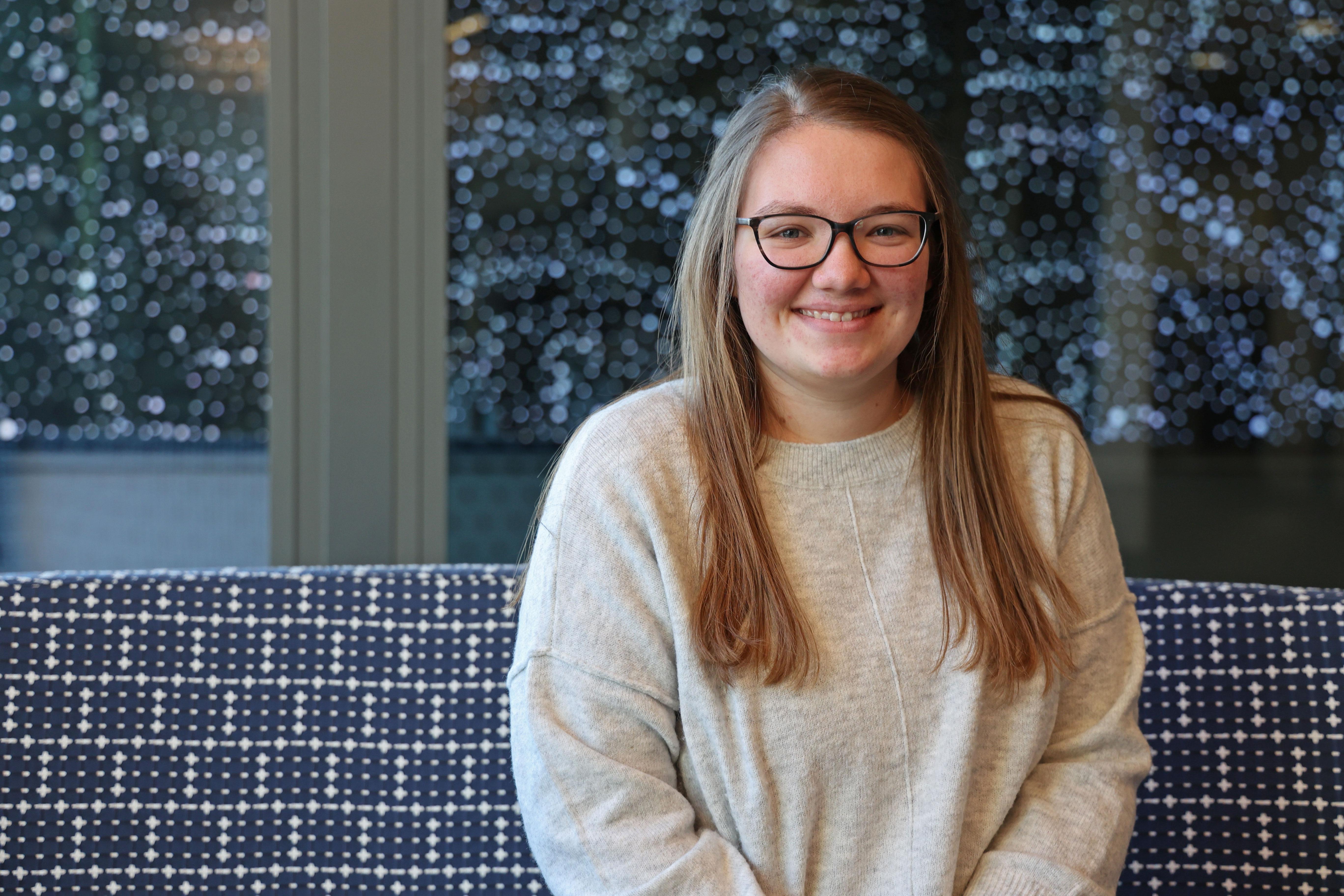 Jullian, posing for a photo at the site of her marketing internship in Cedar Rapids