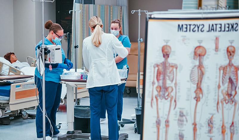 A student and professor using the state-of-the-art nursing sim lab