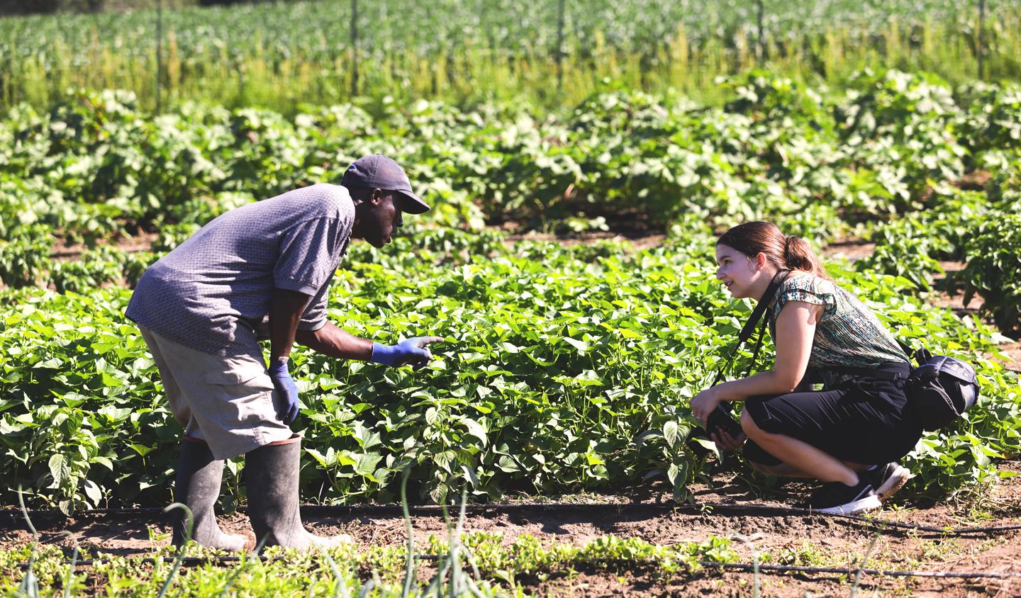 Darius Nupolu and Hallie Eickhoff posing in the middle of Dows Farm for Feed Iowa First