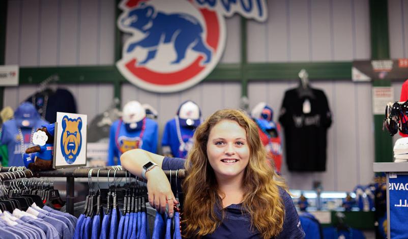 Katelyn Kral, posing in front of the Iowa Cubs logo